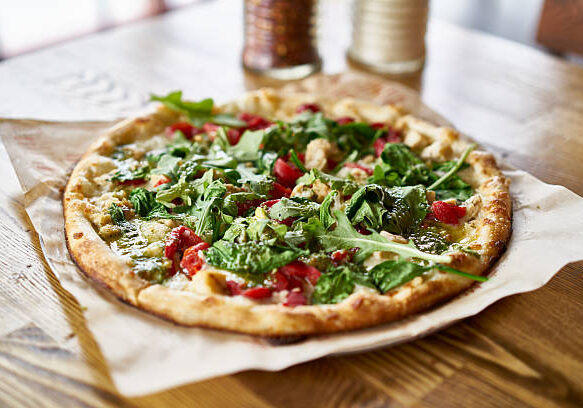 fresh brick oven fired pizza on table top in restaurant